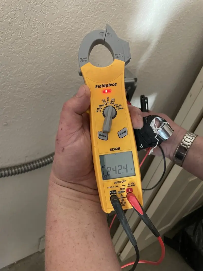 Voltage testing with clamp meter during Outlet Installation in Boston